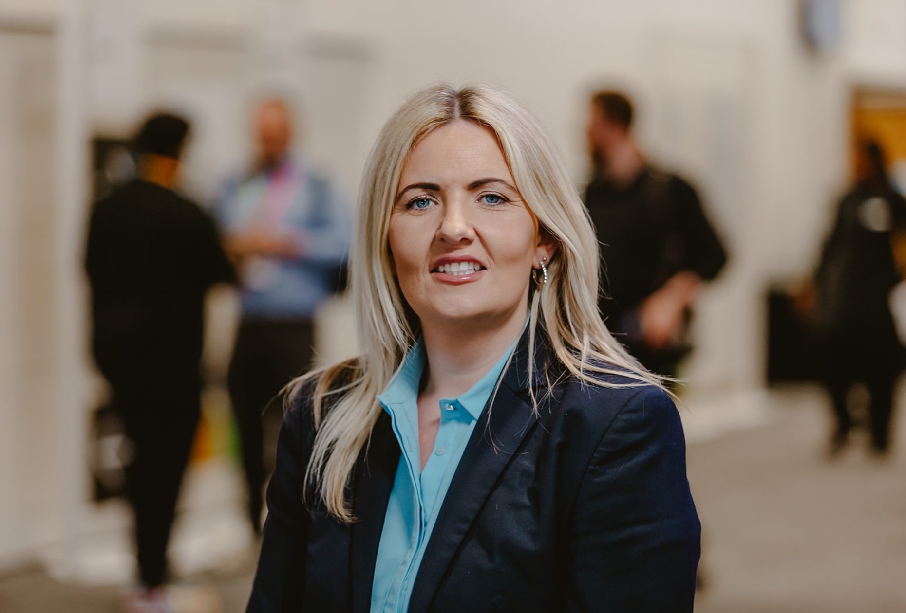 Operations Assistant, Katrina Crossett photographed outside of Hall 2 with event on behind her