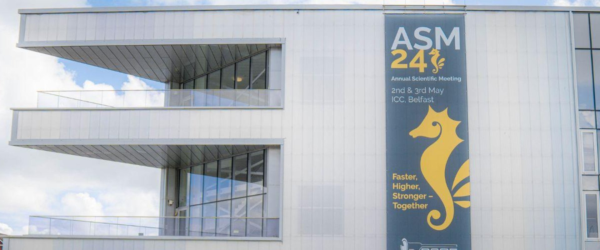 Exterior image of ICC Belfast with BSGE ASM 2024 branding displayed on the side of the venue.
