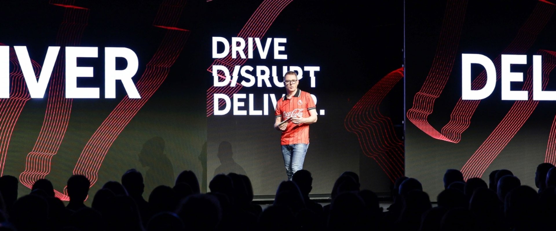 Man talks on stage during conference