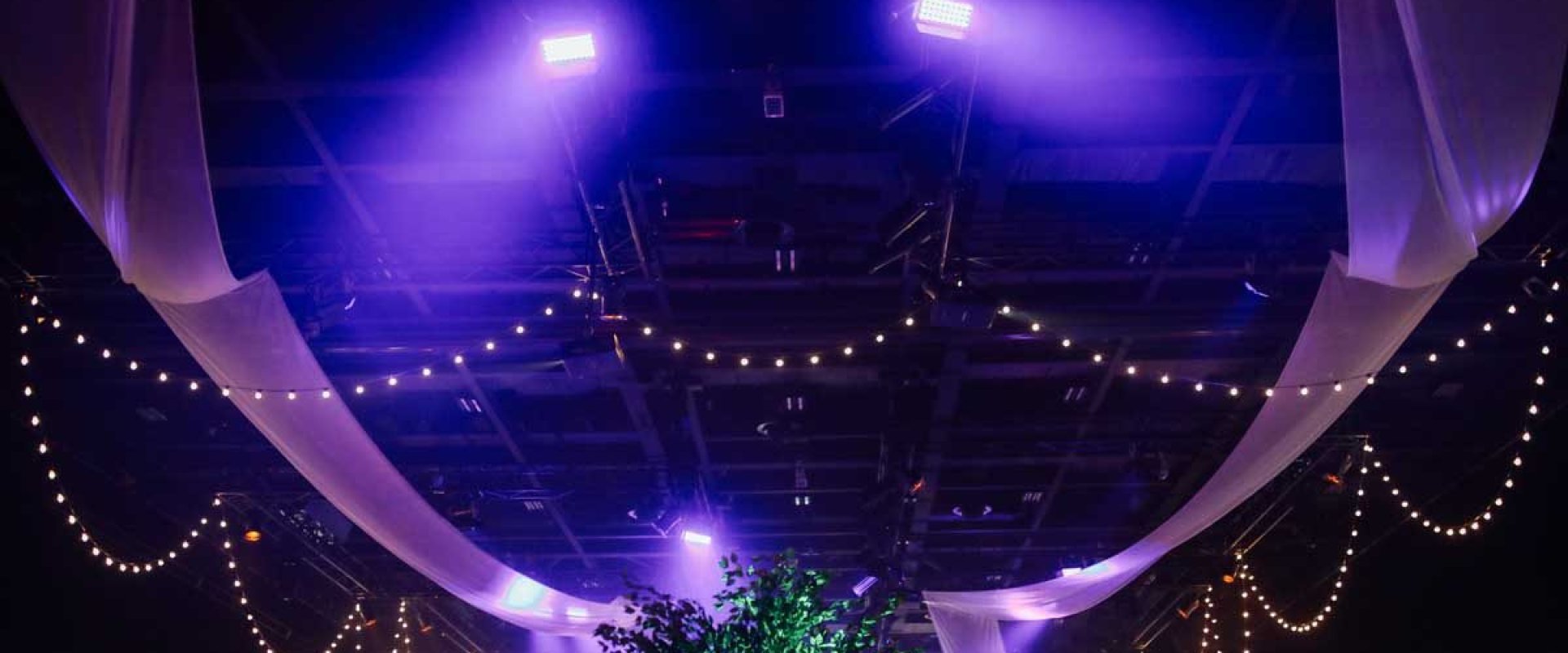 Hall one, black draped dressed room with beaming pink light