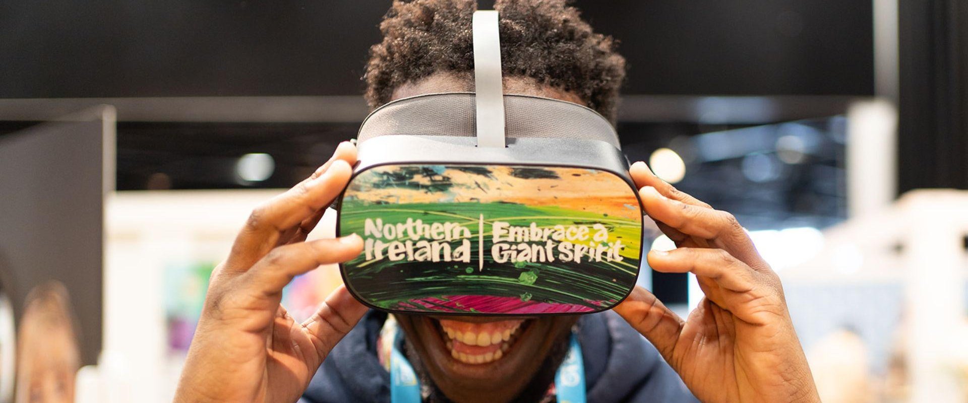 Delegate uses virtual reality headset at Tourism Northern Ireland Stand in Hall 1 at One Young World Summit 2023