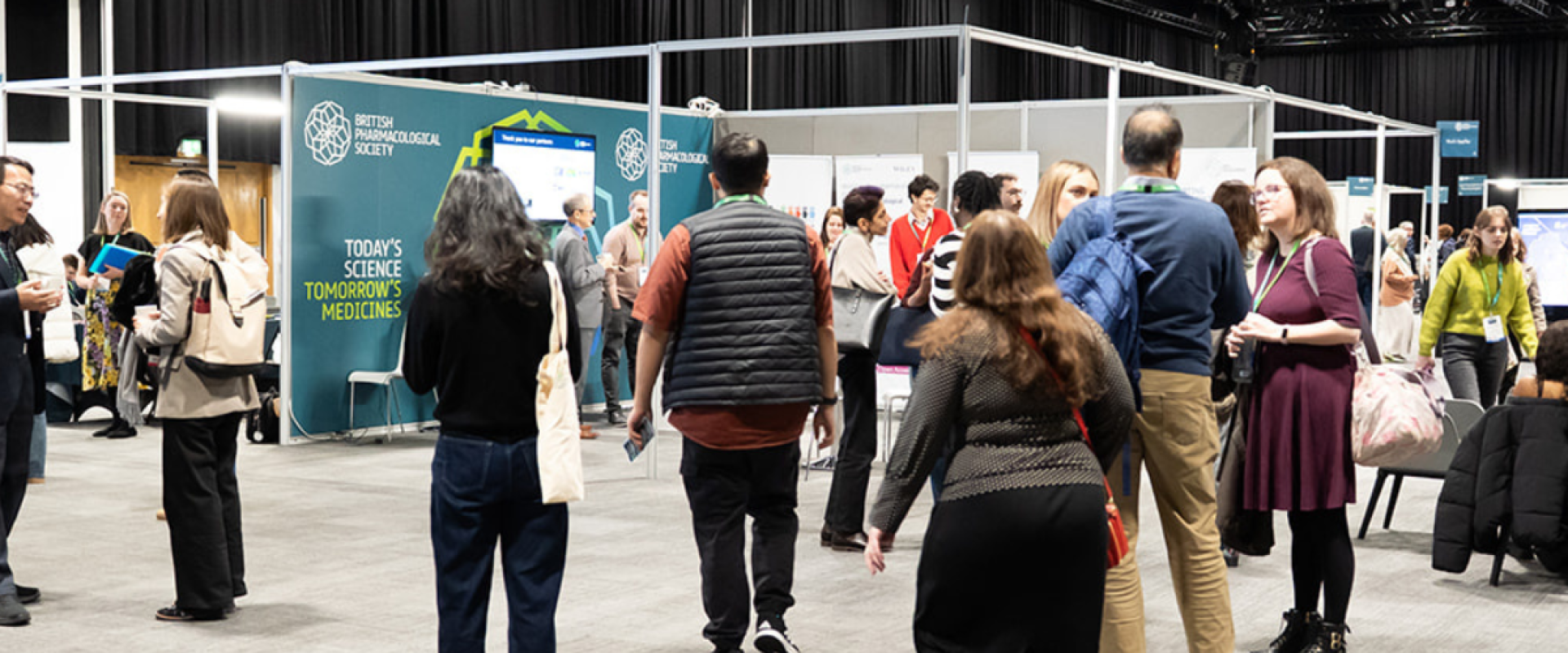 Delegates networking and exploring exhibition stands during a conference at ICC Belfast.