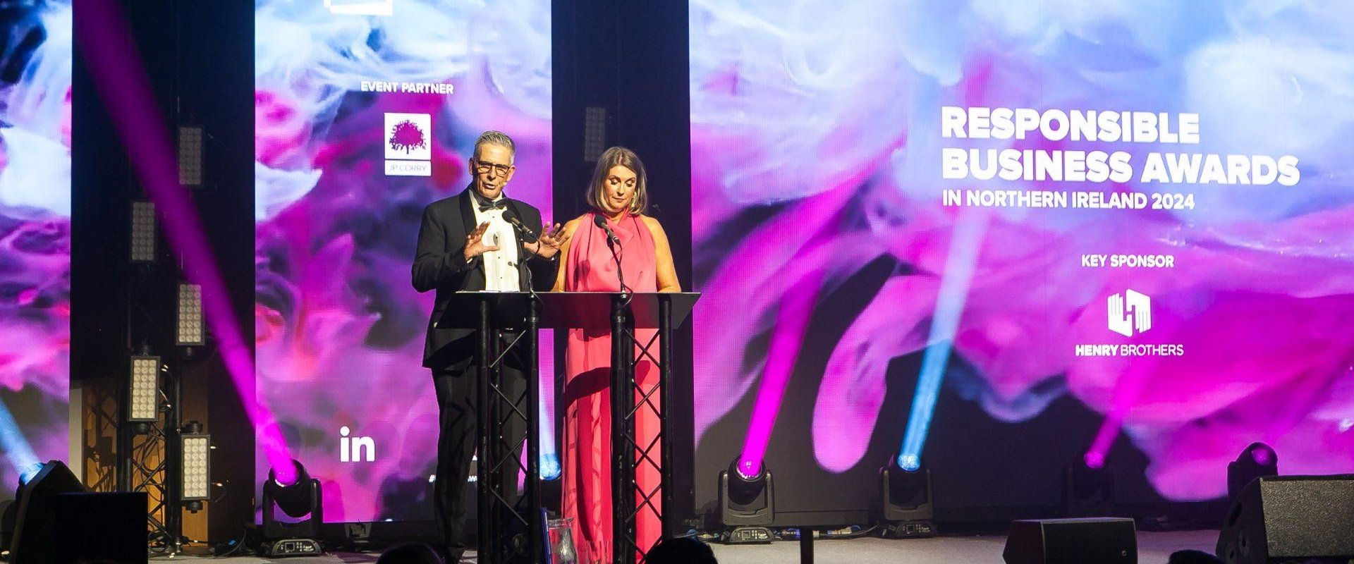 Presenters Mark Simpson and Sarah Travers on Hall 1 stage for the Business In the Community (BITC) NI Responsible Business Awards 2024