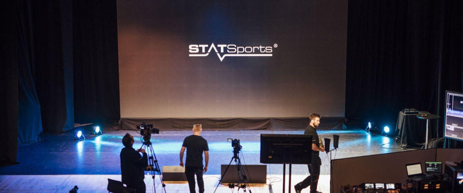 Behind the scenes of the hybrid STATSport product launch event in ICC Belfast's Hybrid Studio. Members of the production team are visible along with a screen with the STATSports logo.