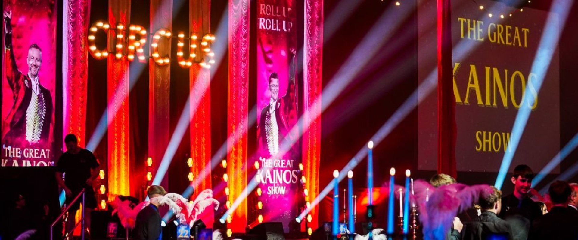 The Greatest Show corporate event set up in Hall 1. 'Circus' is in LED lights on the red curtains with strobe lights shining from the stage as delegates start to gather.