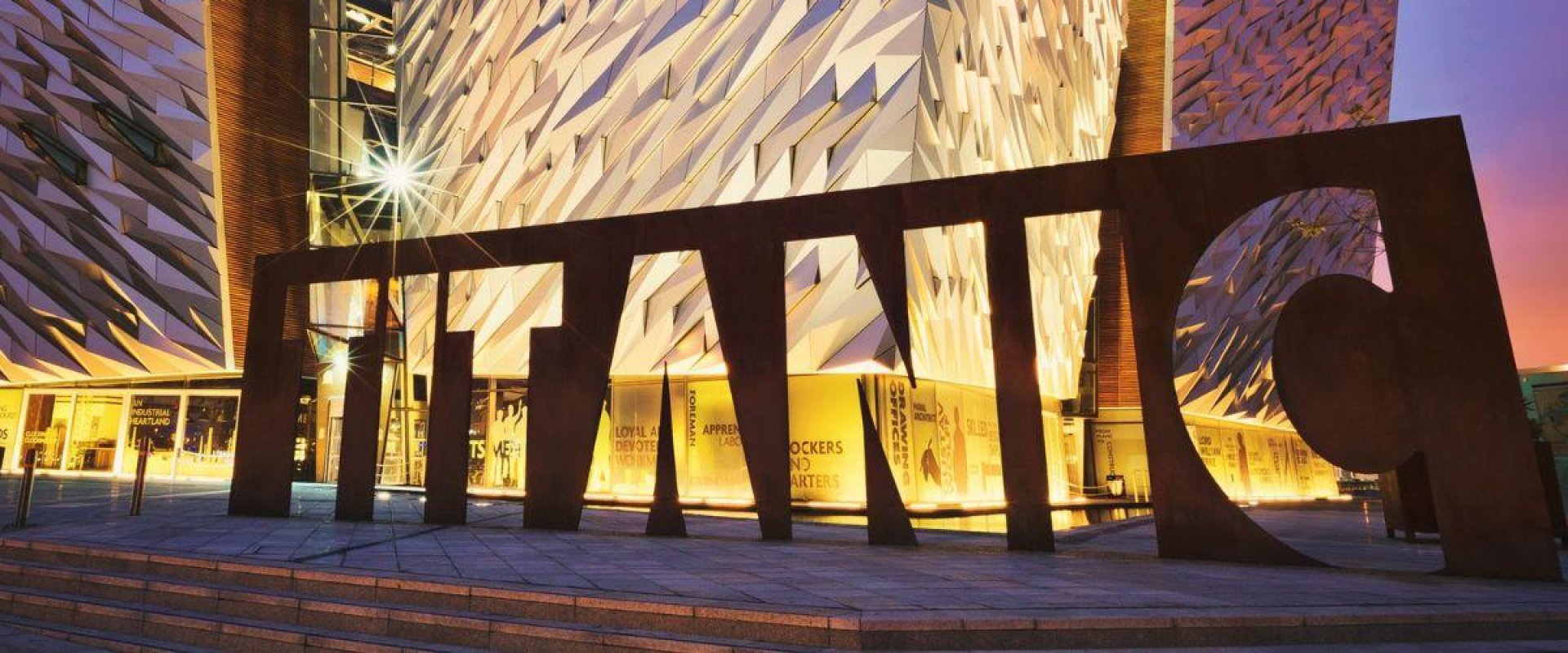 An image of the Titanic Belfast venue lit up at night