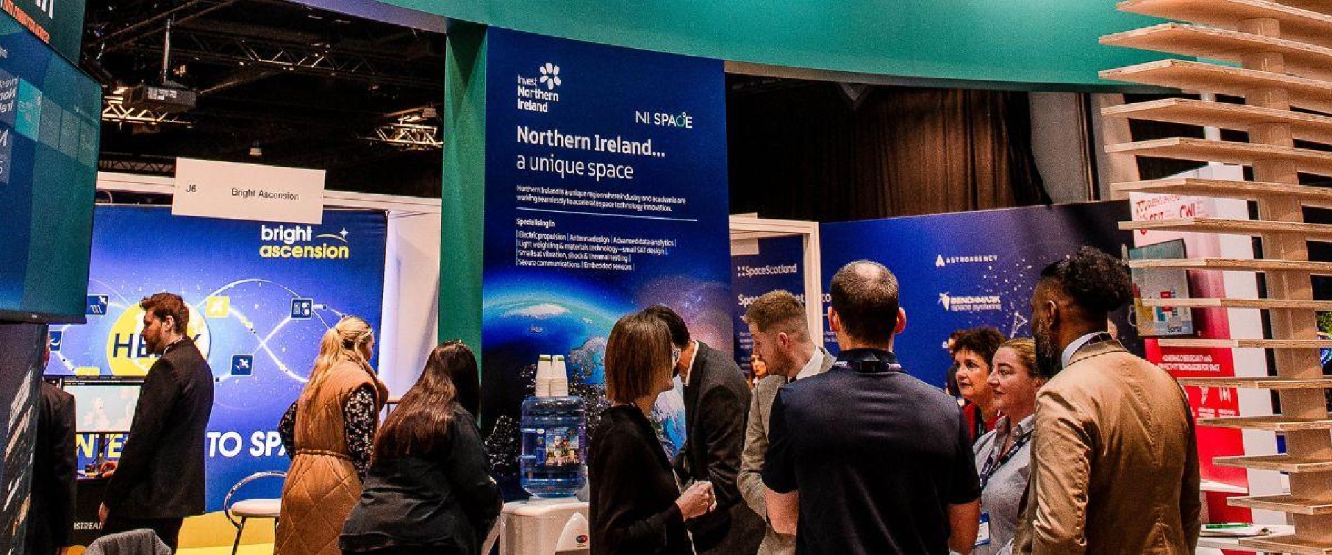 Invest Northern Ireland stand in Hall 2 at the UK Space Conference 2023, as delegates gather round.
