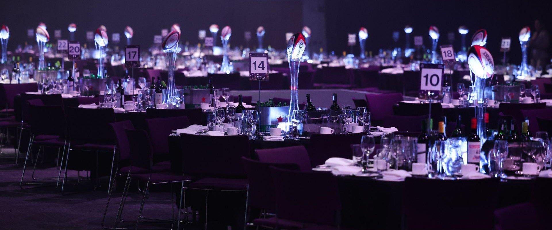 ICC Belfast's Hall 1 set up for the Ulster Rugby Gala Dinner in banquet style. The tables are all numbered and have a rugby ball as a centrepiece.