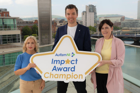 Two woman and one man stand on balcony for Autism Impact Award press shot