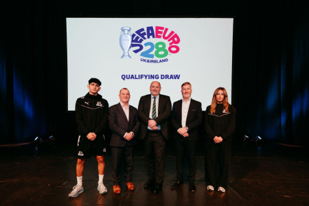 Four men and one women stand for a press shot against a white background with the UEFA Euro 2028 logo in colour displayed behind them