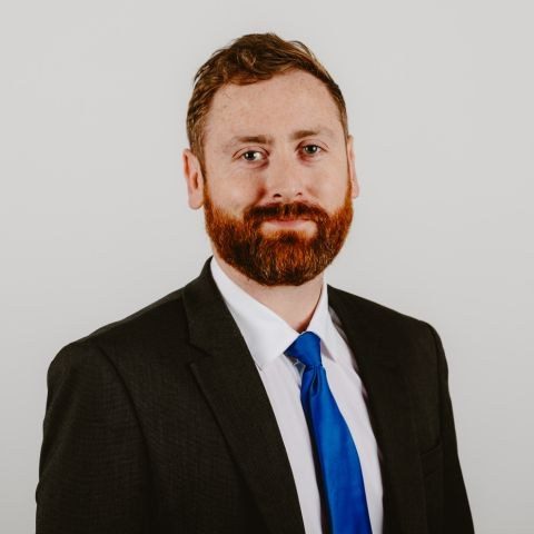 Man smiling for headshot against white background