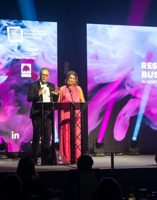 Presenters Mark Simpson and Sarah Travers on Hall 1 stage for the NI Responsible Business Awards 2024