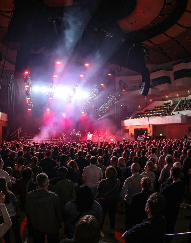 Rock band Elbow play on stage at the Waterfront Hall, Main Auditorium with hundred of people in the crowd facing forward