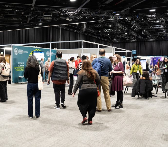 Delegates networking and exploring exhibition stands during a conference at ICC Belfast.