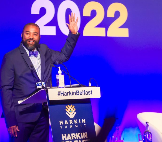 Dr Joseph Jones, Executive Director at Harkin Institute waved on stage to people in the crowd
