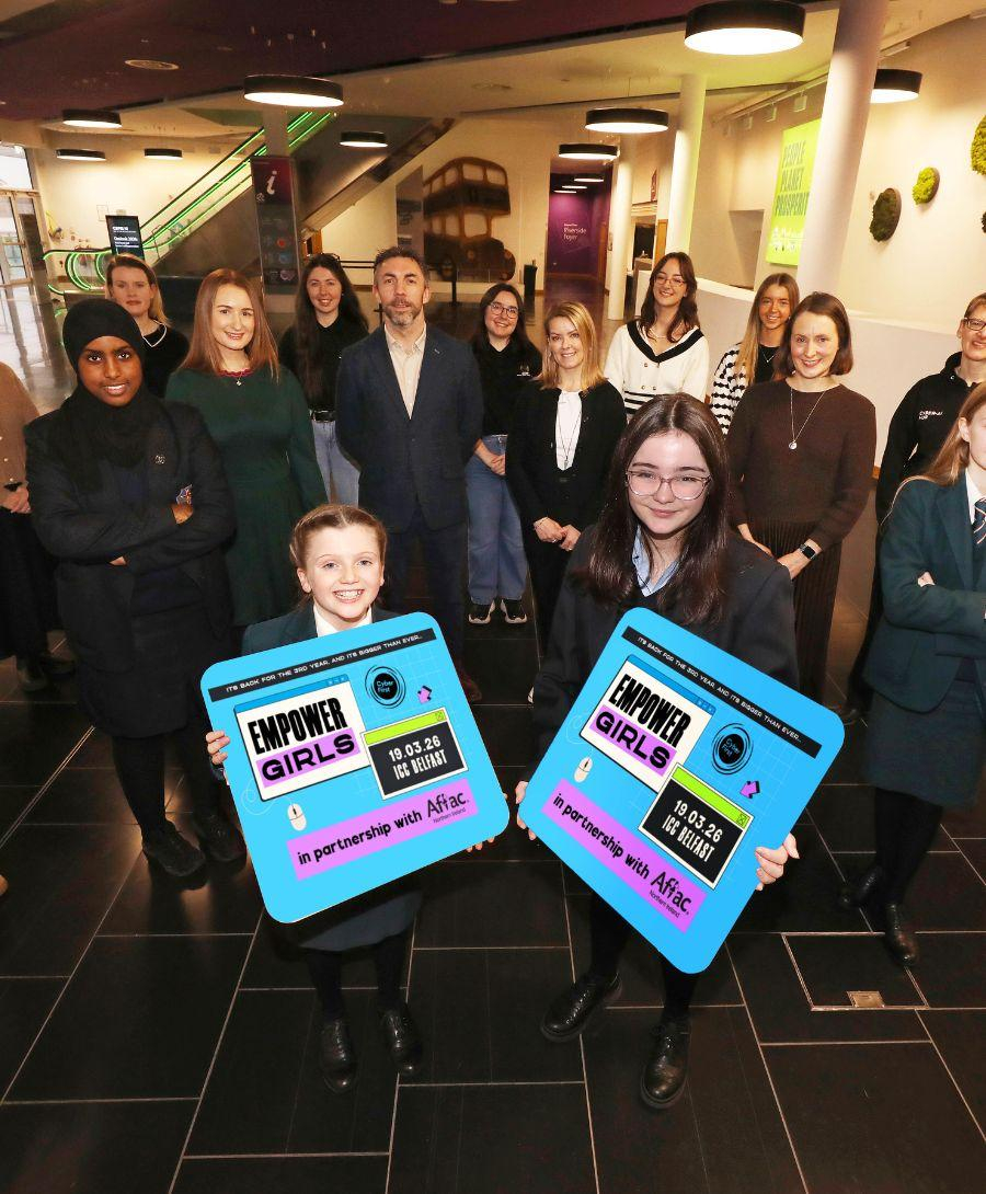 Group of students alongside industry professionals smile for Empower Girls press shot at ICC Belfast