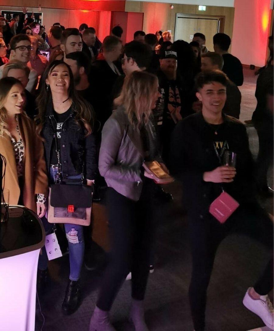 Male and female attendees standing in Hall 2 at ICC Belfast enjoying the product launch event.