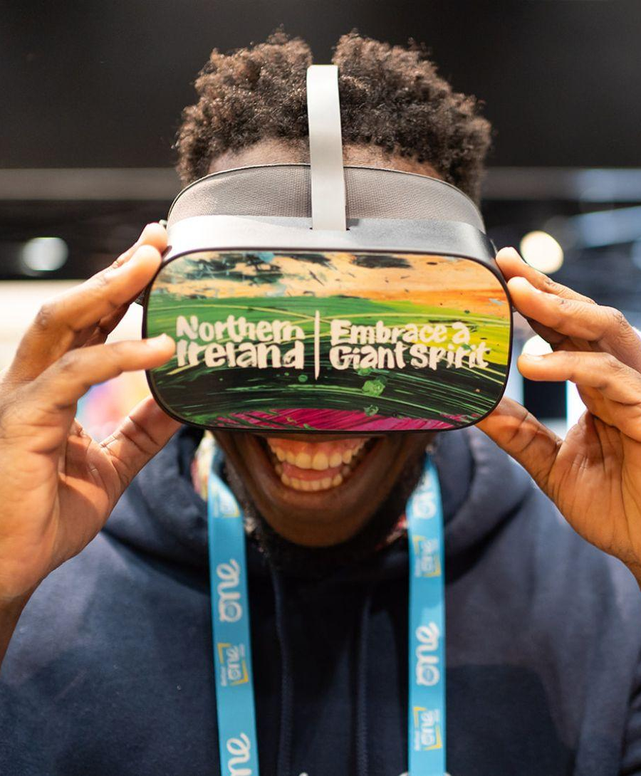 Delegate uses virtual reality headset at Tourism Northern Ireland Stand in Hall 1 at One Young World Summit 2023