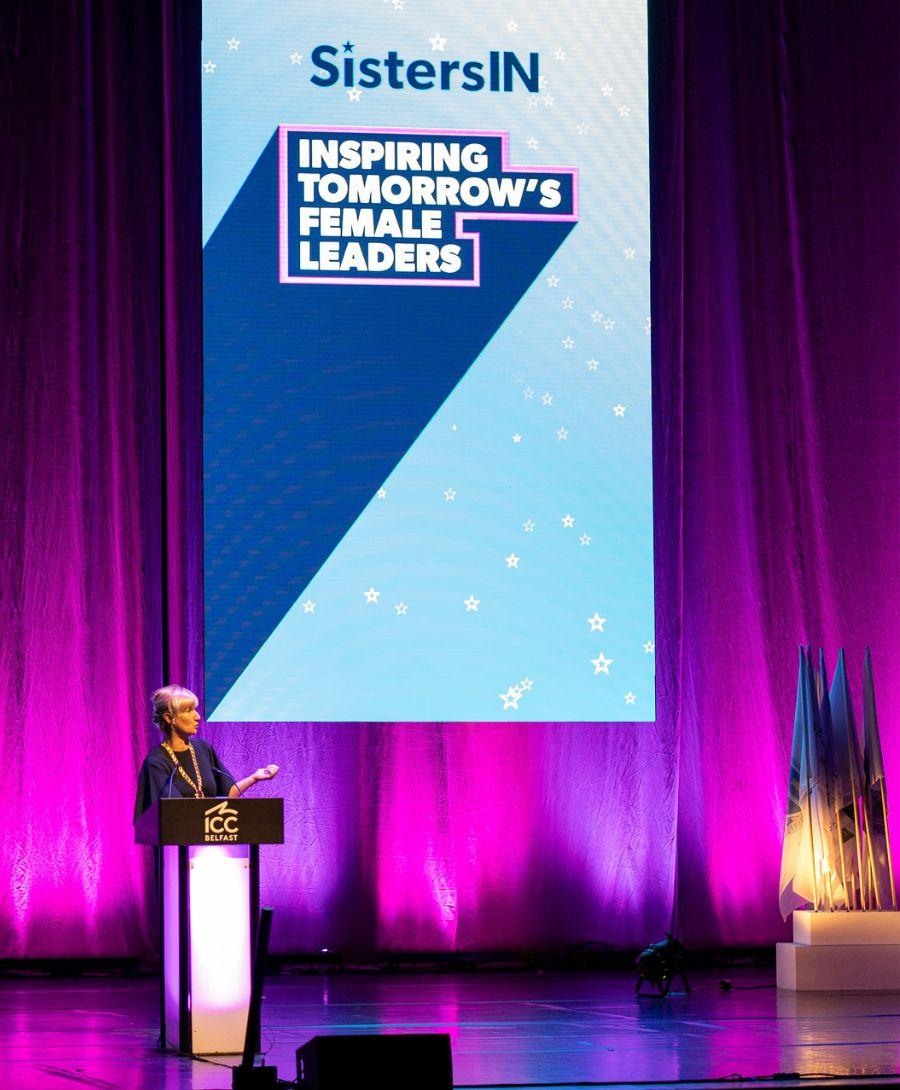 Gill Tiernay on stage in the main auditorium giving a keynote speech at the SistersIN 2024 Celebration Event