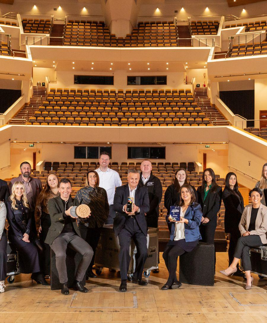 ICC Belfast, Waterfront Hall and Ulster Hall team pictured holding triple awards in Main Auditorium