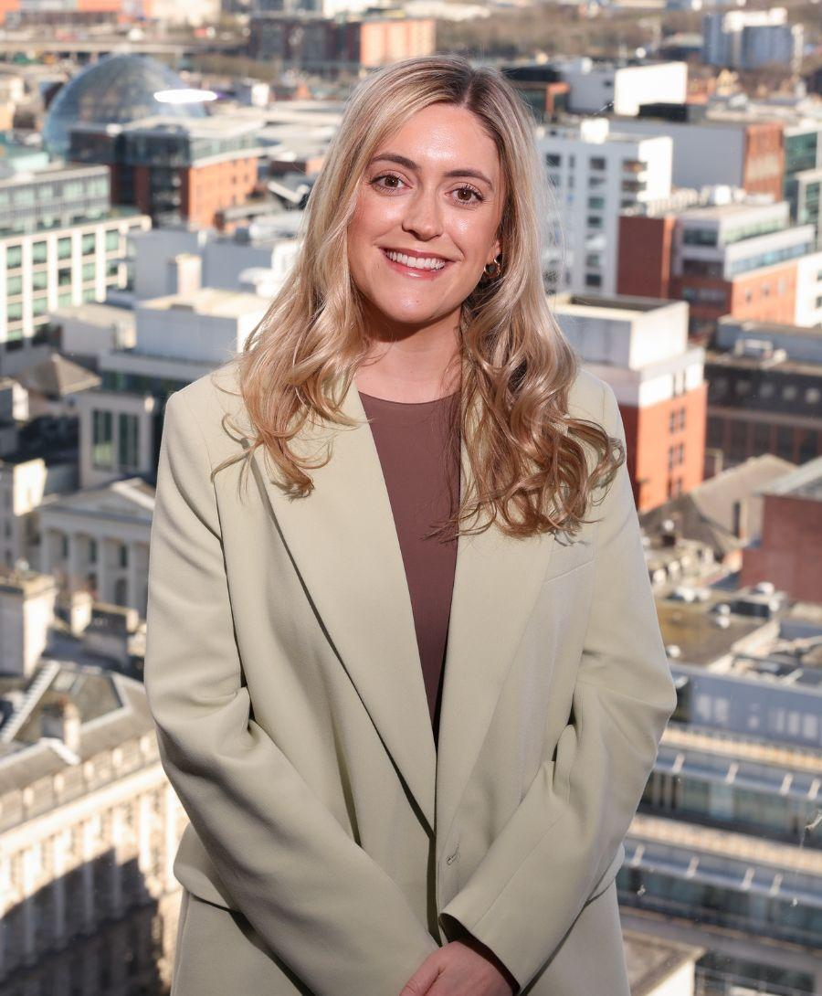 Woman smiling against background of Belfast city skyline