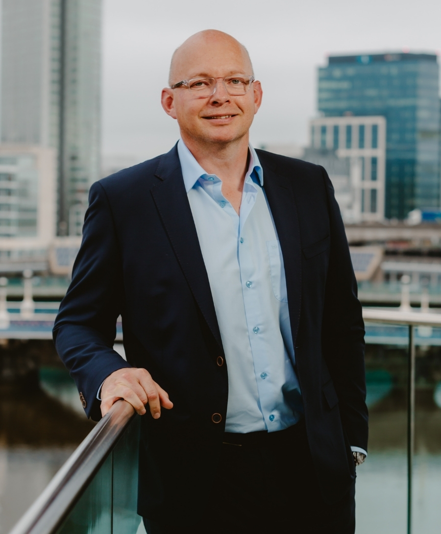 Andrew Dougan, Managing Director of ICC Belfast's food and beverage partner, photographed with Belfast skyline in the background.