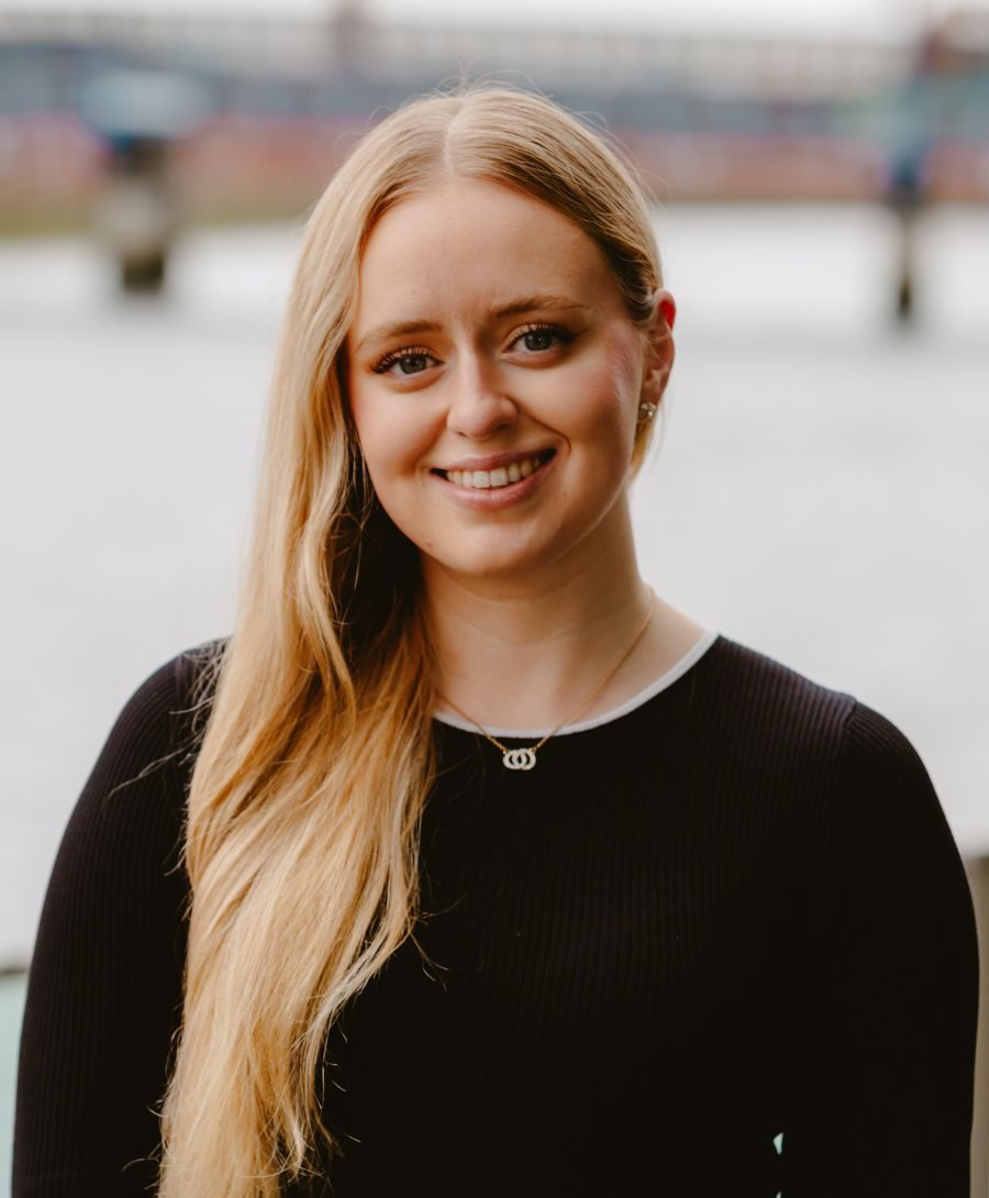 Image of woman smiling next to river