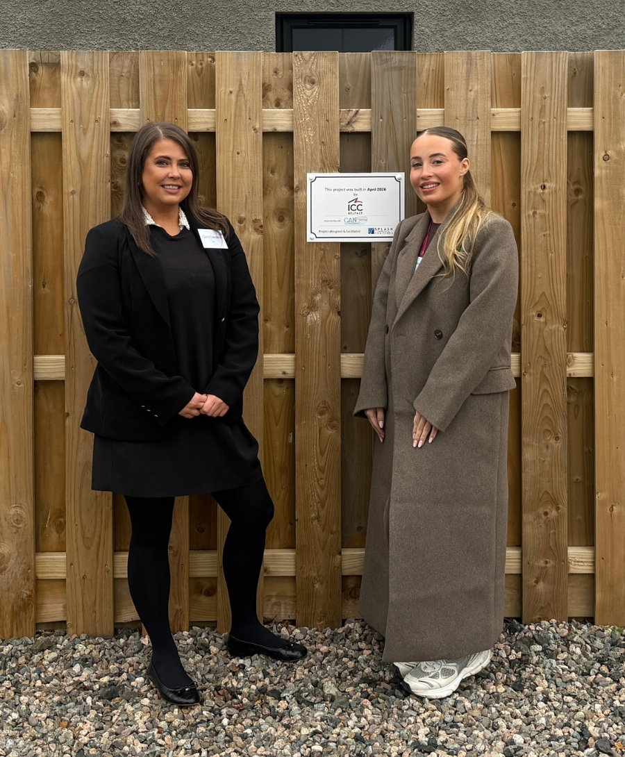 Two female professionals smile for press shot
