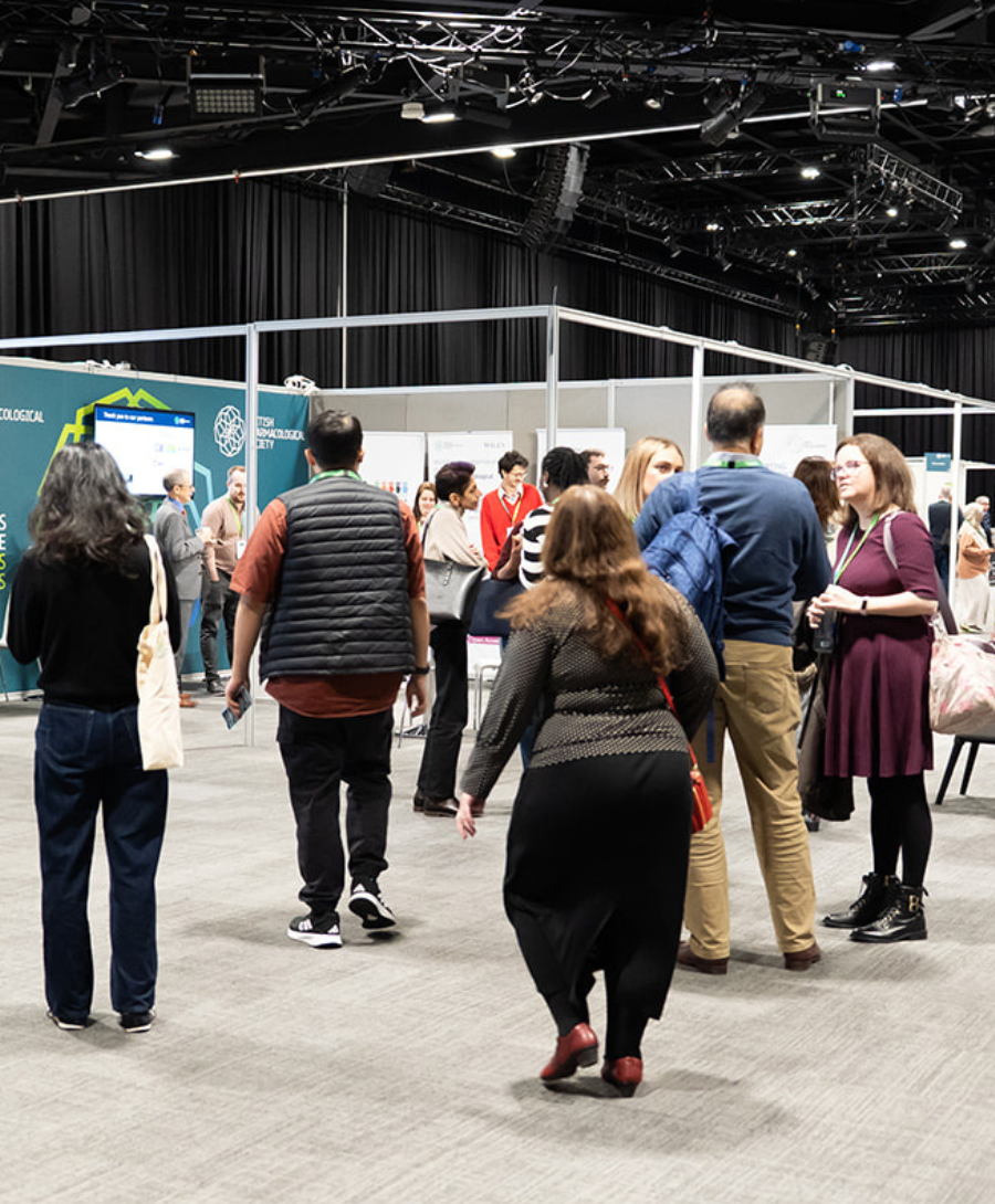 Delegates networking and exploring exhibition stands during a conference at ICC Belfast.