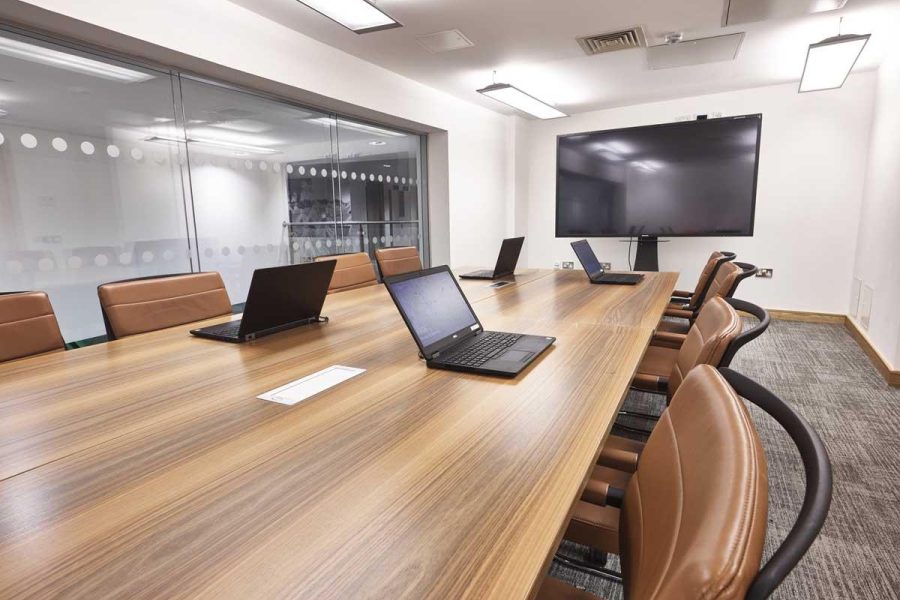 Boardroom 2 with 82” 4K screen and laptops