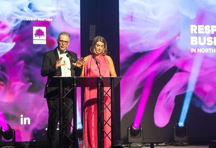 Presenters Mark Simpson and Sarah Travers on Hall 1 stage for the NI Responsible Business Awards 2024