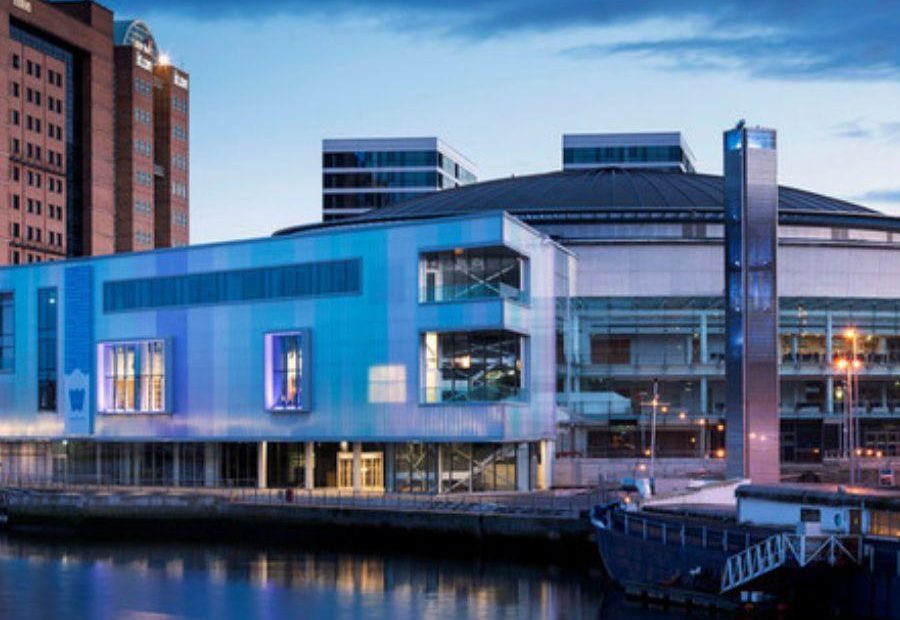 This image shows the exterior of the riverside part of ICC Belfast at dusk.