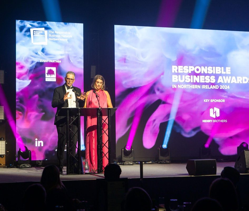 Presenters Mark Simpson and Sarah Travers on Hall 1 stage for the NI Responsible Business Awards 2024