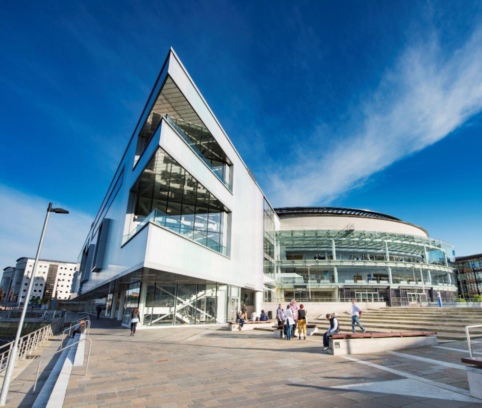 Image shows steps leading down to Riverside Entrance at ICC Belfast with balconies and the curved glass Waterfron Hall building in view.