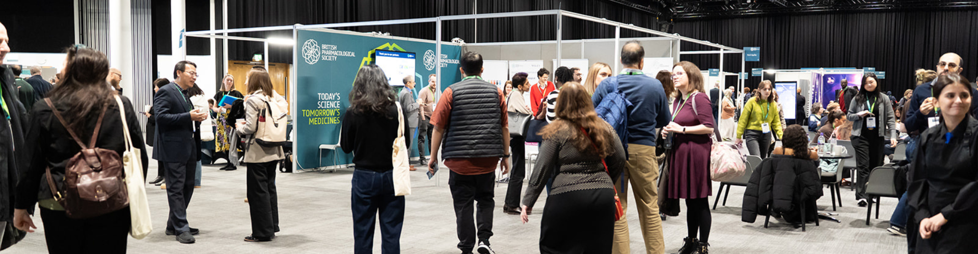 Delegates networking and exploring exhibition stands during a conference at ICC Belfast.